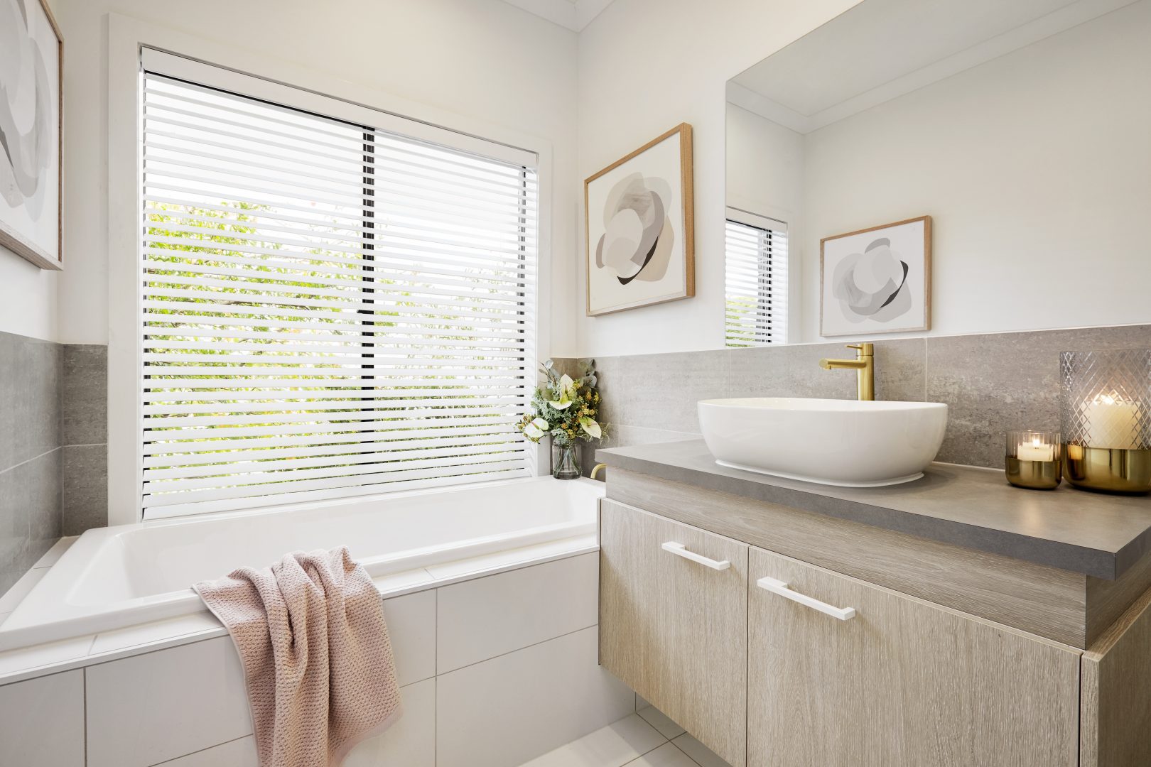 White venetian blinds added to a bright bathroom with white and neutral furniture