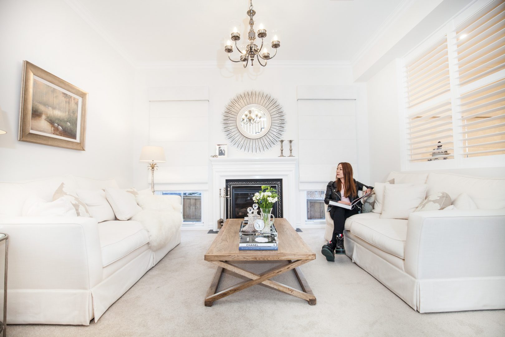 Bright white living room with timber coffee table and white roman blinds