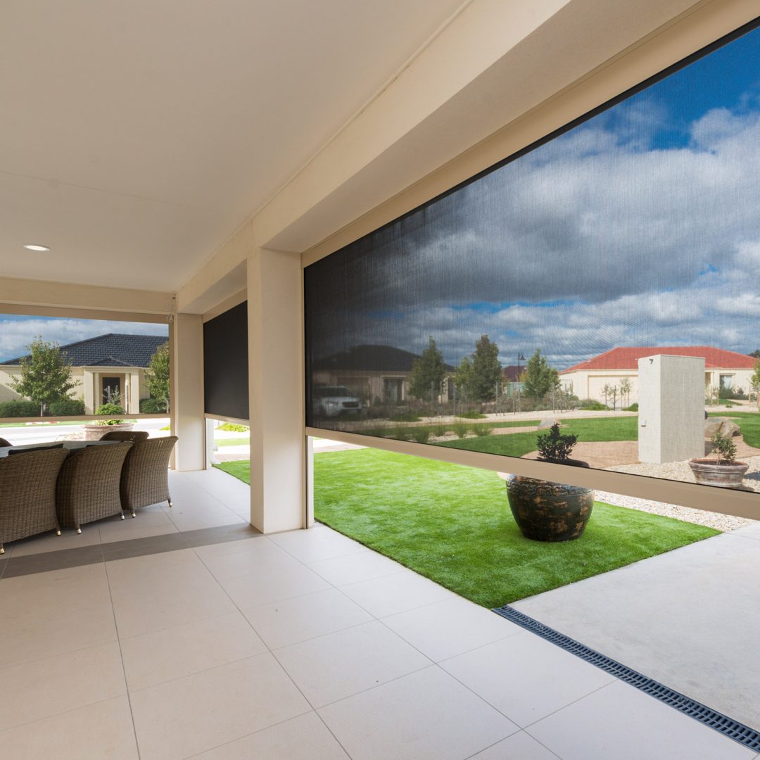 Light filtering awning fitted around outdoor dining area and patio