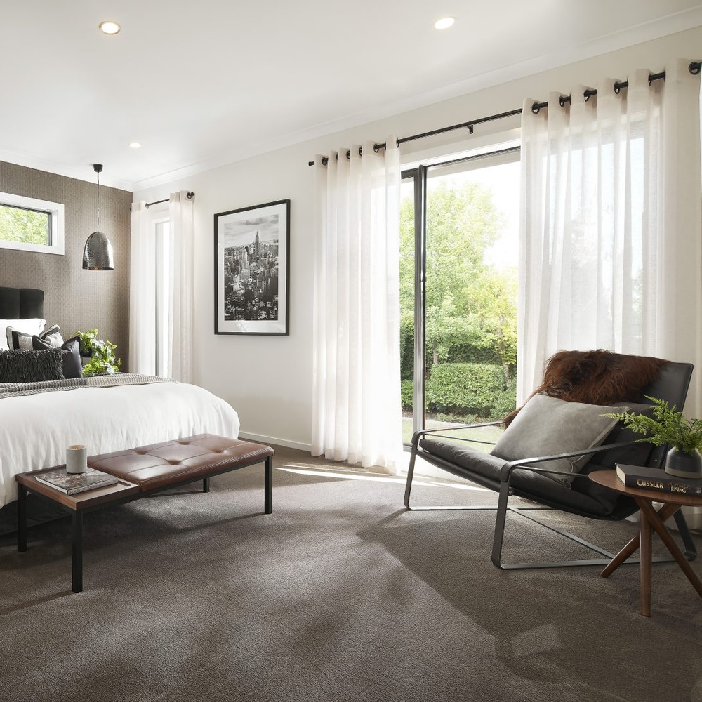 A-large-bedroom-with-a-king-bed-double-eyelet-curtains