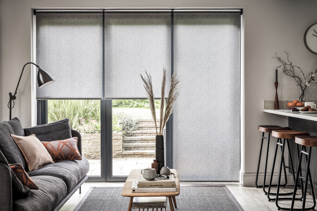 Modern living room with sofa coffee table charcoal sheer roller blinds on window