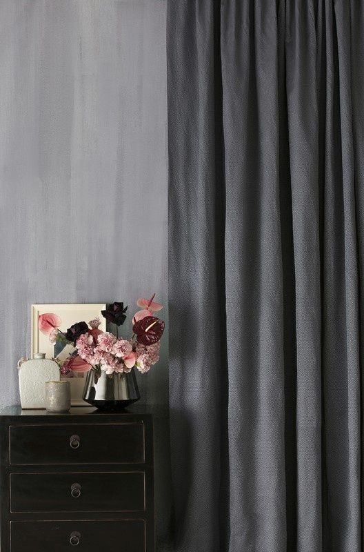 Room featuring light grey pinch pleat curtains, complementing the soft and neutral decor for an elegant and understated look